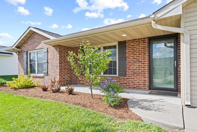 property entrance featuring brick siding