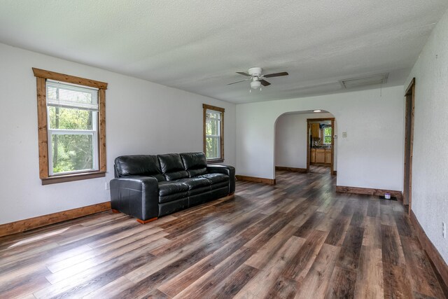 5435 N Creasy Springs Rd, Columbia, MO 65202 - living area featuring a ceiling fan, visible vents, arched walkways, wood finished floors, and baseboards