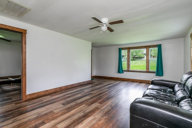 5435 N Creasy Springs Rd, Columbia, MO 65202 - living area featuring a ceiling fan, dark wood-style flooring, a textured ceiling, visible vents, and baseboards