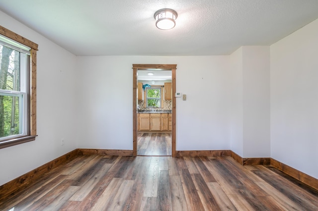 5435 N Creasy Springs Rd, Columbia, MO 65202 - spare room with baseboards, a textured ceiling, and wood finished floors