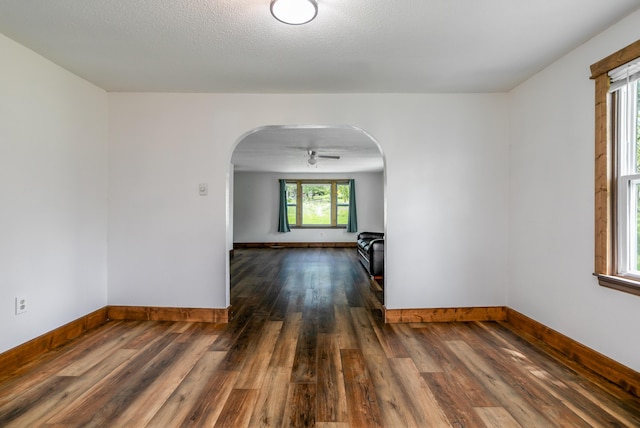 5435 N Creasy Springs Rd, Columbia, MO 65202 - empty room with arched walkways, baseboards, and wood finished floors