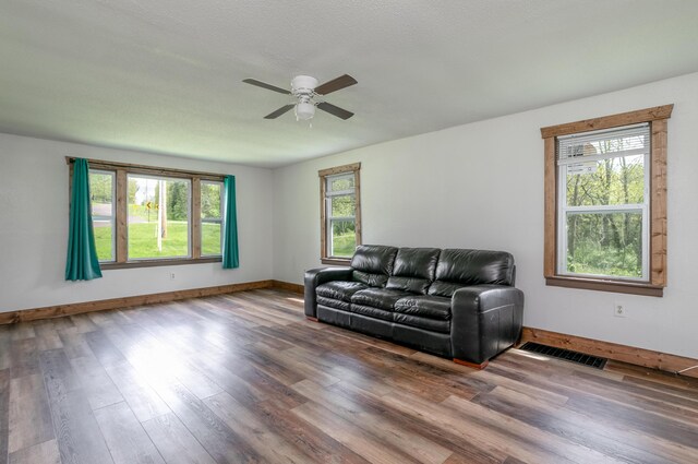 5435 N Creasy Springs Rd, Columbia, MO 65202 - living area featuring baseboards, ceiling fan, visible vents, and wood finished floors
