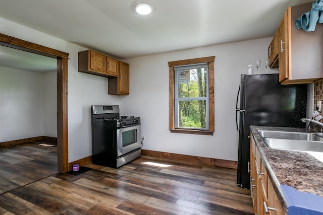 5435 N Creasy Springs Rd, Columbia, MO 65202 - kitchen with a sink, dark wood finished floors, brown cabinets, and stainless steel gas range