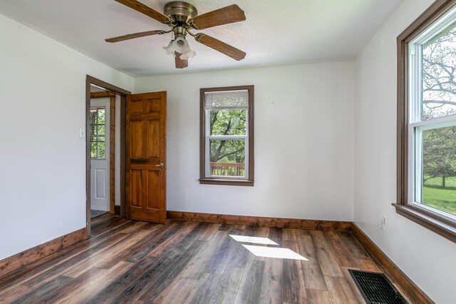 5435 N Creasy Springs Rd, Columbia, MO 65202 - spare room featuring dark wood-style floors, visible vents, and plenty of natural light
