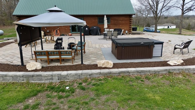view of patio featuring a hot tub, a gazebo, an outdoor hangout area, and a grill