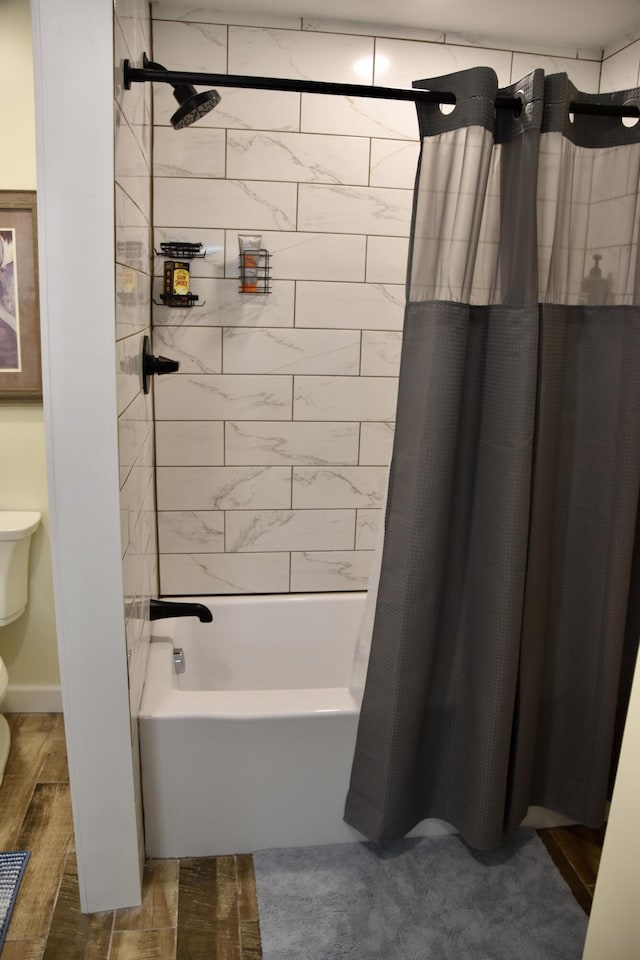 bathroom featuring toilet and shower / tub combo