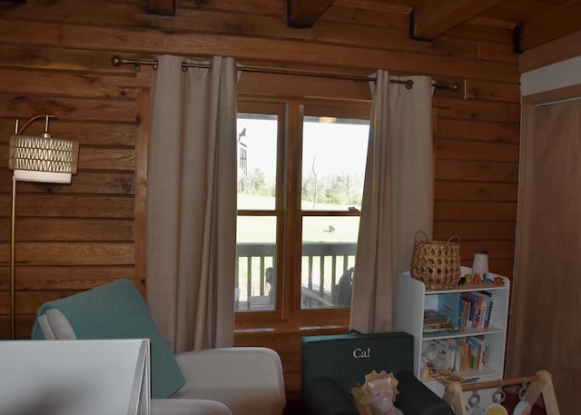 entryway featuring wooden walls and beam ceiling