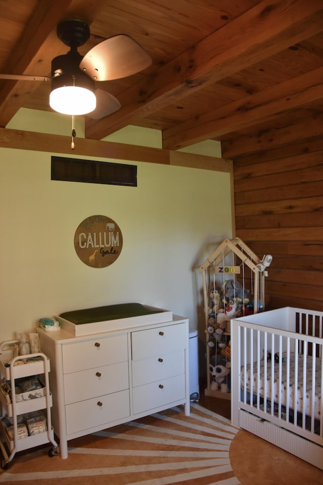 bedroom with wooden ceiling, beamed ceiling, and wood walls