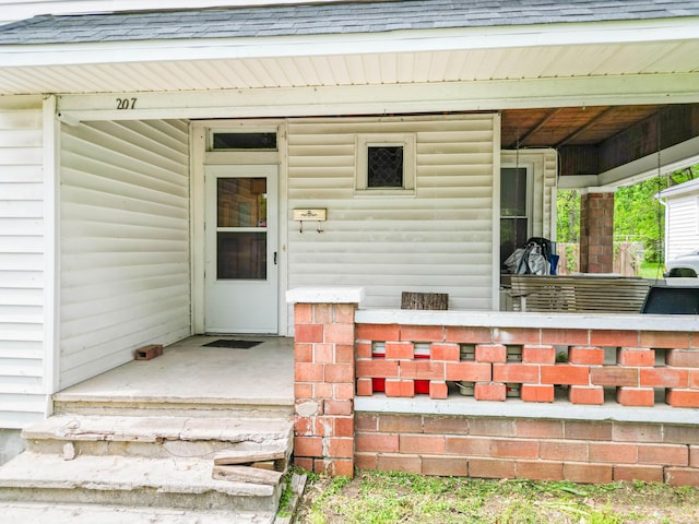 207 Lucky St, Fayette, MO 65248 - doorway to property with roof with shingles and covered porch