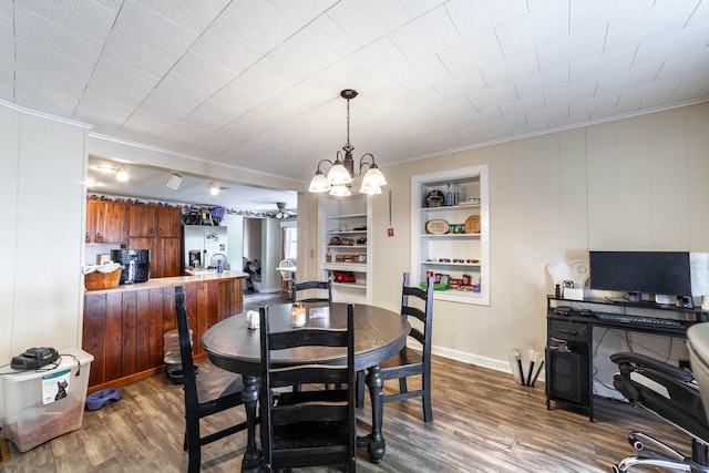 207 Lucky St, Fayette, MO 65248 - dining space with an inviting chandelier, ornamental molding, baseboards, and dark wood-style floors