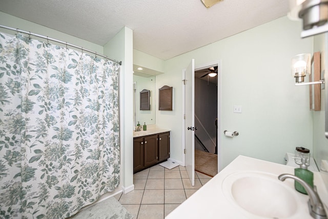 bathroom featuring vanity, curtained shower, a textured ceiling, tile patterned floors, and a ceiling fan