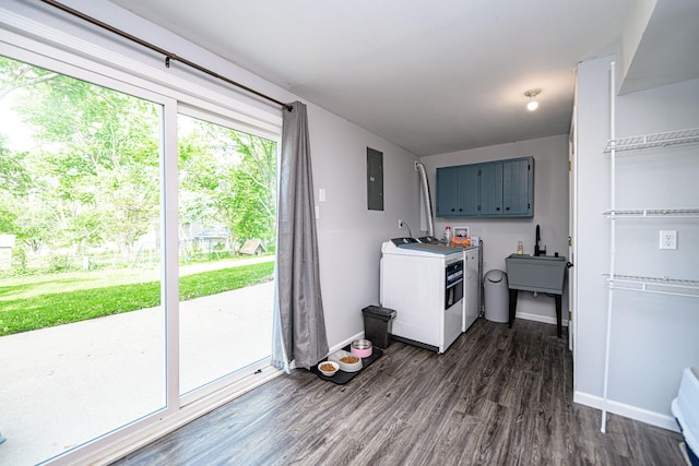 washroom with electric panel, cabinet space, separate washer and dryer, dark wood-style flooring, and baseboards