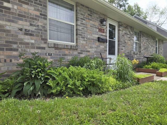 doorway to property featuring brick siding