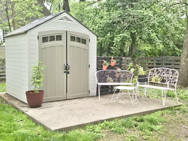 view of shed with fence