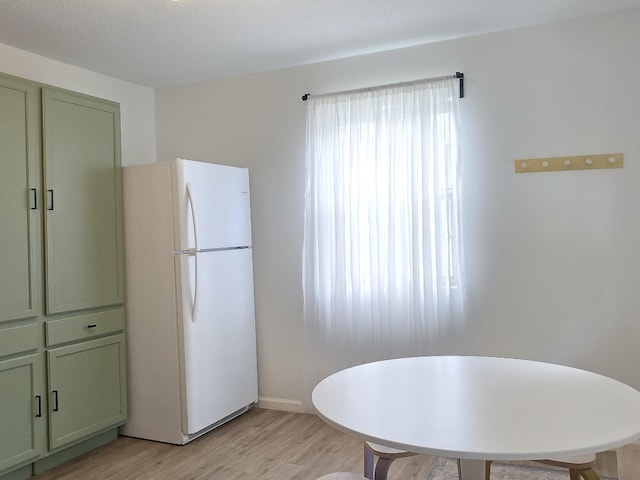 dining room with light wood-style flooring