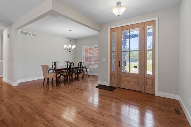 4520 County Road 1245, Moberly, MO 65270 - entryway with an inviting chandelier, baseboards, hardwood / wood-style flooring, and visible vents