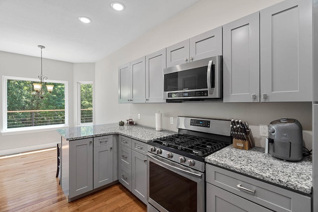 4520 County Road 1245, Moberly, MO 65270 - kitchen with gray cabinets, a peninsula, light wood-style floors, stainless steel appliances, and recessed lighting