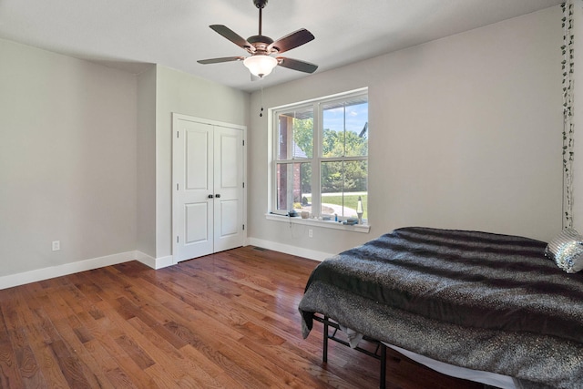 4520 County Road 1245, Moberly, MO 65270 - bedroom featuring baseboards, ceiling fan, wood finished floors, and a closet