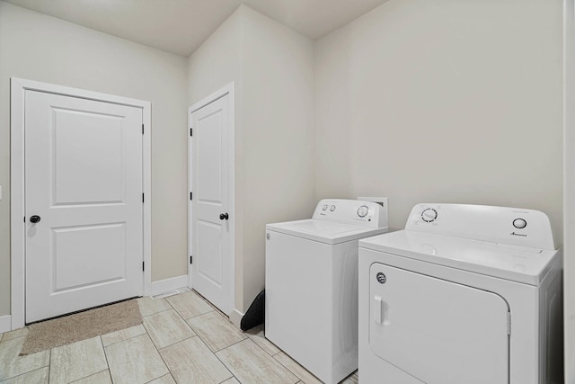 4520 County Road 1245, Moberly, MO 65270 - washroom featuring washing machine and clothes dryer, laundry area, and baseboards