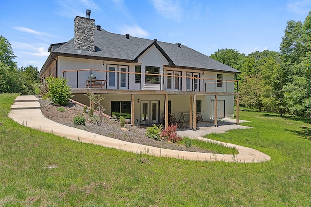 4520 County Road 1245, Moberly, MO 65270 - back of house featuring french doors, a chimney, a wooden deck, a yard, and a patio