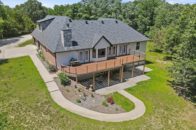 4520 County Road 1245, Moberly, MO 65270 - rear view of property featuring concrete driveway, a yard, and a deck