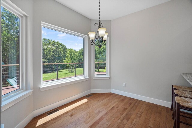 4520 County Road 1245, Moberly, MO 65270 - unfurnished dining area featuring baseboards, an inviting chandelier, visible vents, and light wood-type flooring