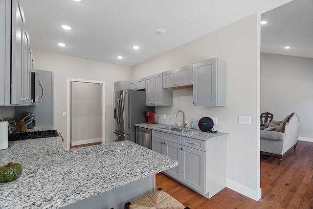 4520 County Road 1245, Moberly, MO 65270 - kitchen with appliances with stainless steel finishes, gray cabinetry, light stone counters, baseboards, and a sink