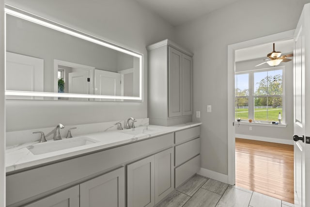 4520 County Road 1245, Moberly, MO 65270 - bathroom with a sink, baseboards, ceiling fan, and double vanity