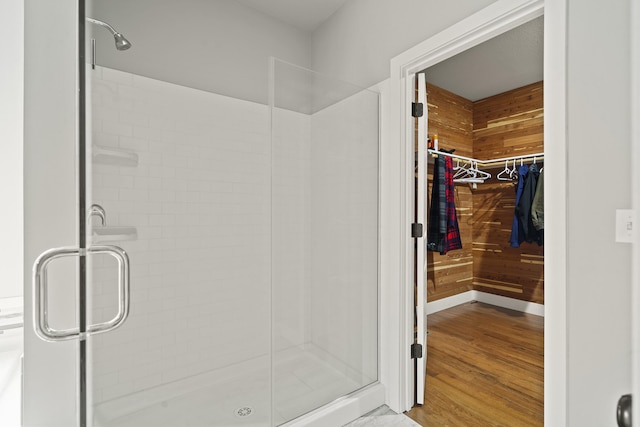 4520 County Road 1245, Moberly, MO 65270 - full bathroom featuring a walk in closet, a stall shower, and wood finished floors