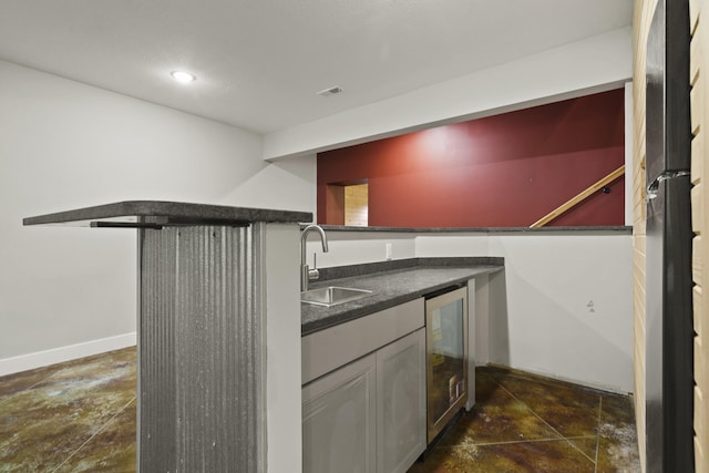4520 County Road 1245, Moberly, MO 65270 - kitchen with visible vents, dark countertops, beverage cooler, stone finish floor, and a sink