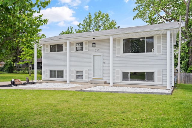 view of front of property featuring a patio area and roof with shingles