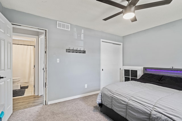 carpeted bedroom with a closet, baseboards, and a ceiling fan