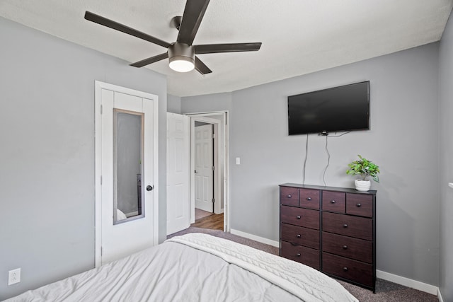 carpeted bedroom with baseboards and a ceiling fan