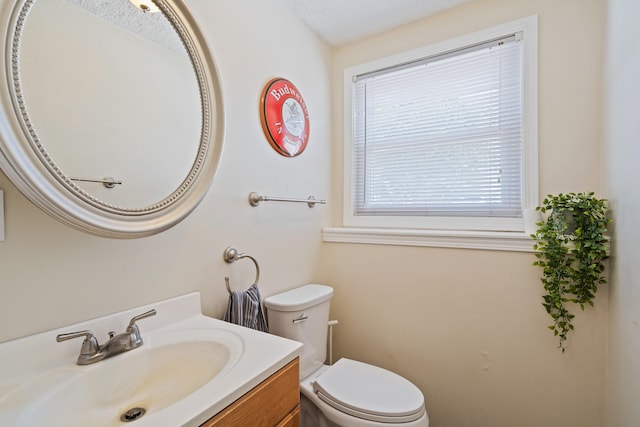 bathroom featuring toilet and vanity