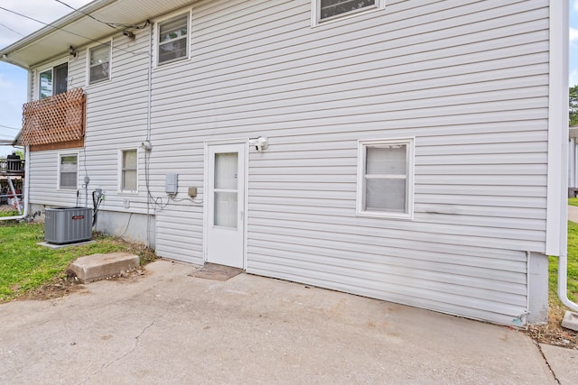 rear view of property with a patio area and central air condition unit