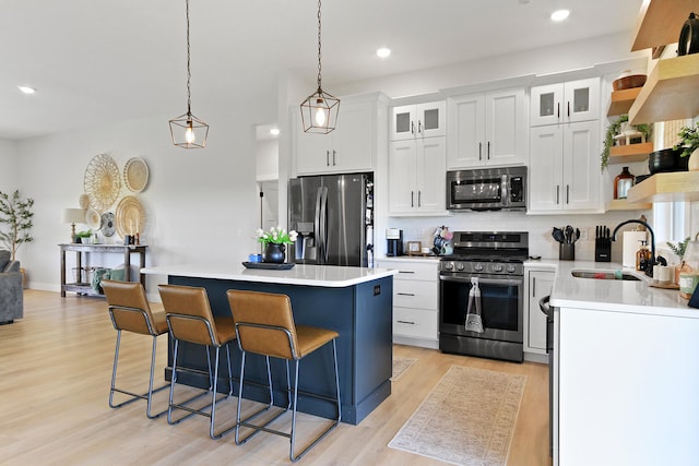 7495 N Rte Z, Columbia, MO 65202 - kitchen featuring a center island, a sink, open shelves, a kitchen breakfast bar, and appliances with stainless steel finishes