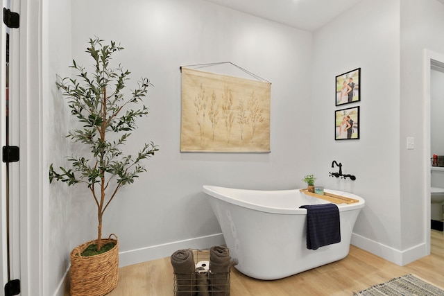 7495 N Rte Z, Columbia, MO 65202 - full bath featuring a freestanding bath, toilet, baseboards, and wood finished floors