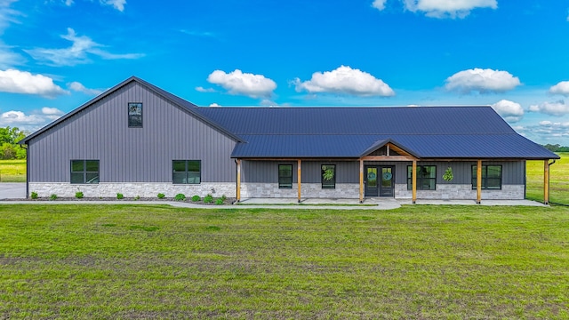 7495 N Rte Z, Columbia, MO 65202 - view of front facade with stone siding, metal roof, french doors, and a front lawn