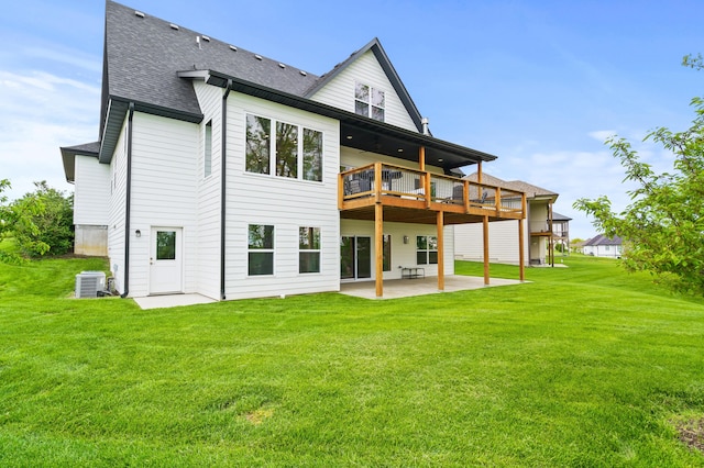 back of house with a patio area, a yard, roof with shingles, and cooling unit