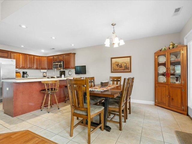 dining area with a chandelier, baseboards, light tile patterned floors, and recessed lighting