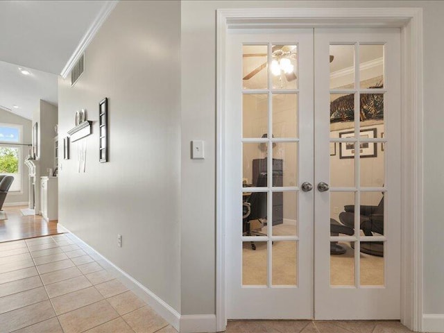 entryway with baseboards, visible vents, french doors, and light tile patterned floors