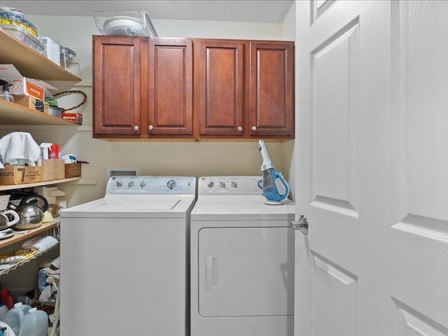 laundry area with washer and dryer and cabinet space