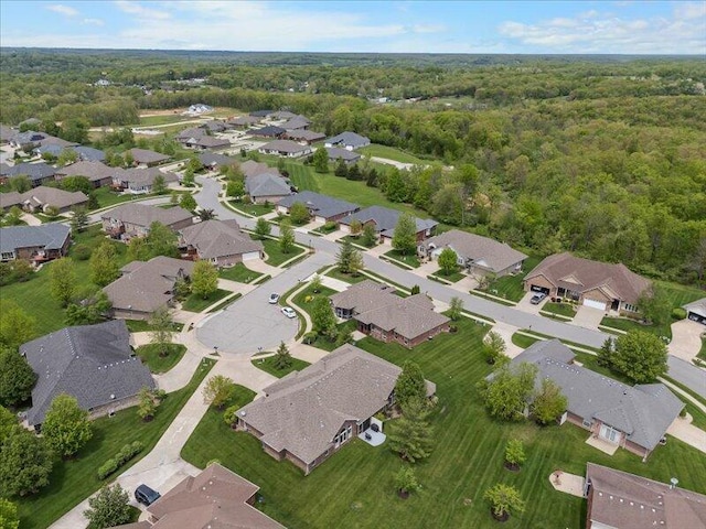 drone / aerial view with a view of trees and a residential view