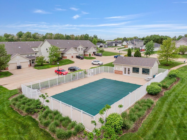 view of swimming pool featuring fence and a residential view