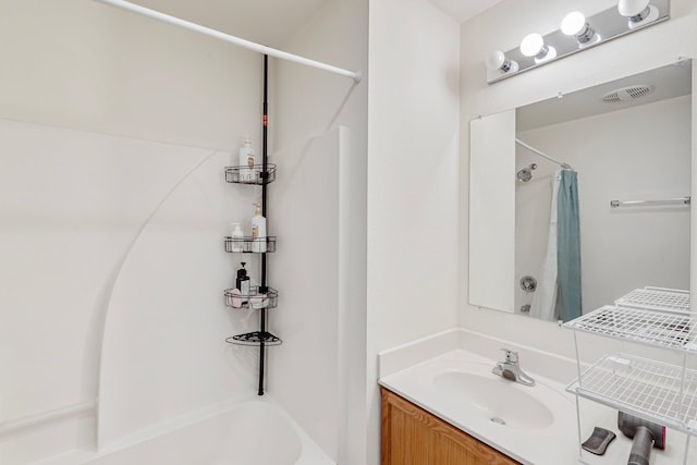 bathroom featuring visible vents, vanity, and shower / tub combo with curtain