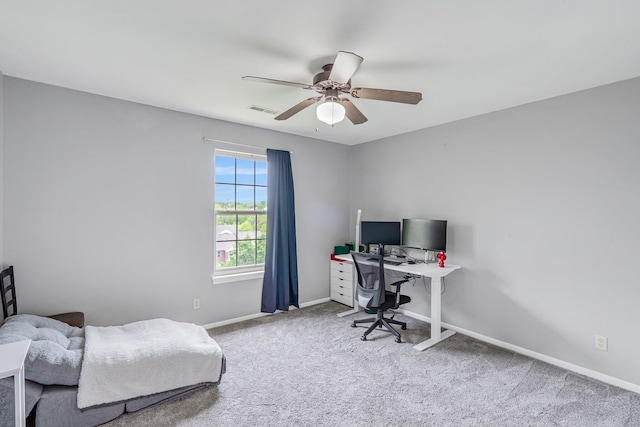 carpeted office with ceiling fan, baseboards, and visible vents