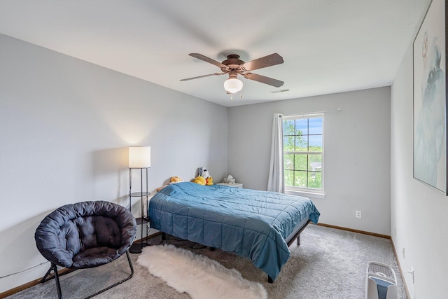 carpeted bedroom featuring baseboards, ceiling fan, and visible vents