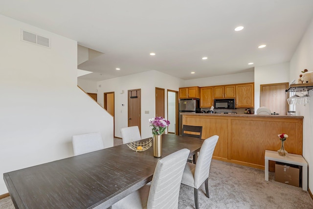 dining room with recessed lighting, visible vents, and light carpet