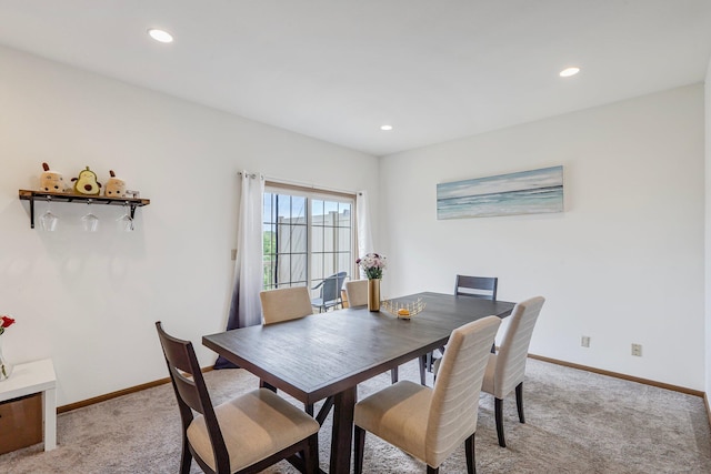dining area featuring light carpet, baseboards, and recessed lighting