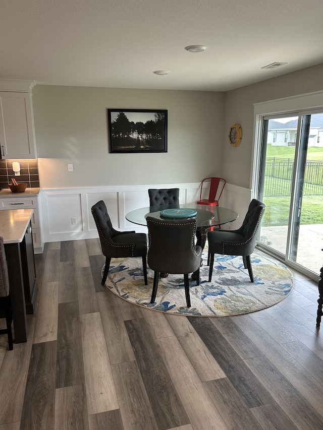1001 Shore Acres Loop, Columbia, MO 65201 - dining space with dark wood-type flooring and wainscoting